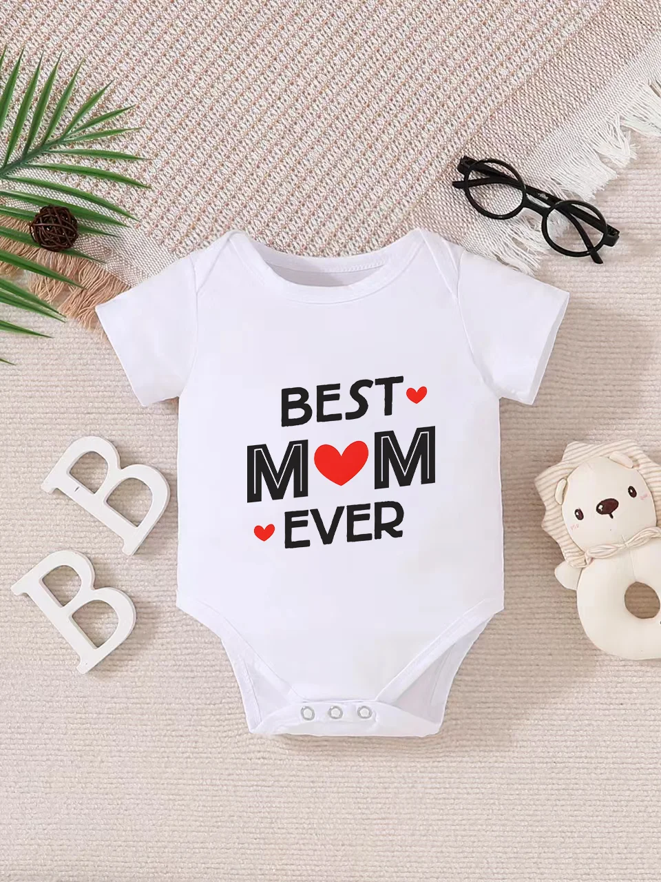 Playful letter-printed baby short-sleeve triangle bodysuit. Button closure for easy dressing, machine washable
