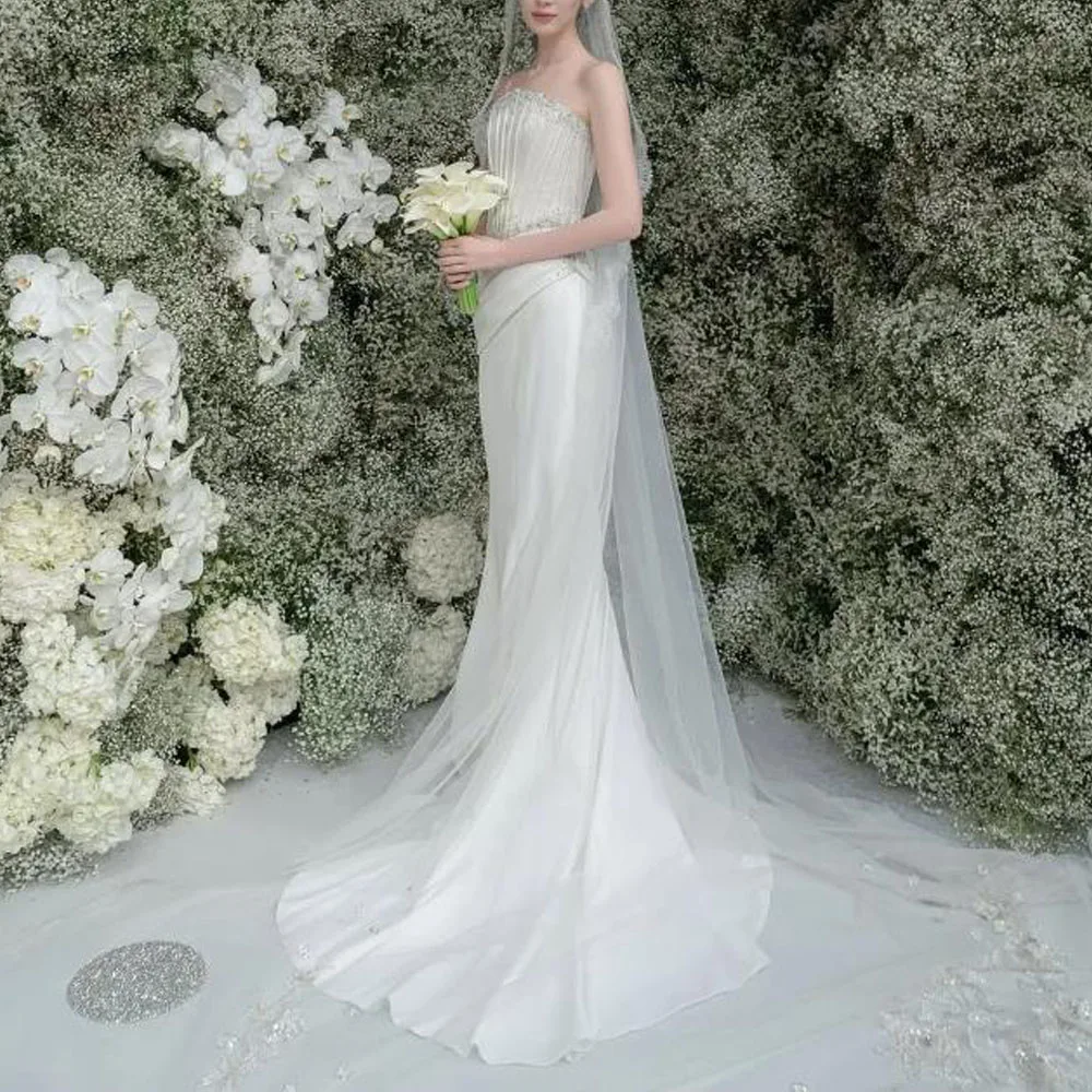 ชุดแต่งงานทรงเมอร์เมดแบบคอร์เซ็ทไร้สาย ปรับแต่งได้ ประดับลูกปัด ผ้าซาติน จับจีบ ทรงเข้ารูป สีขาว ยาว
