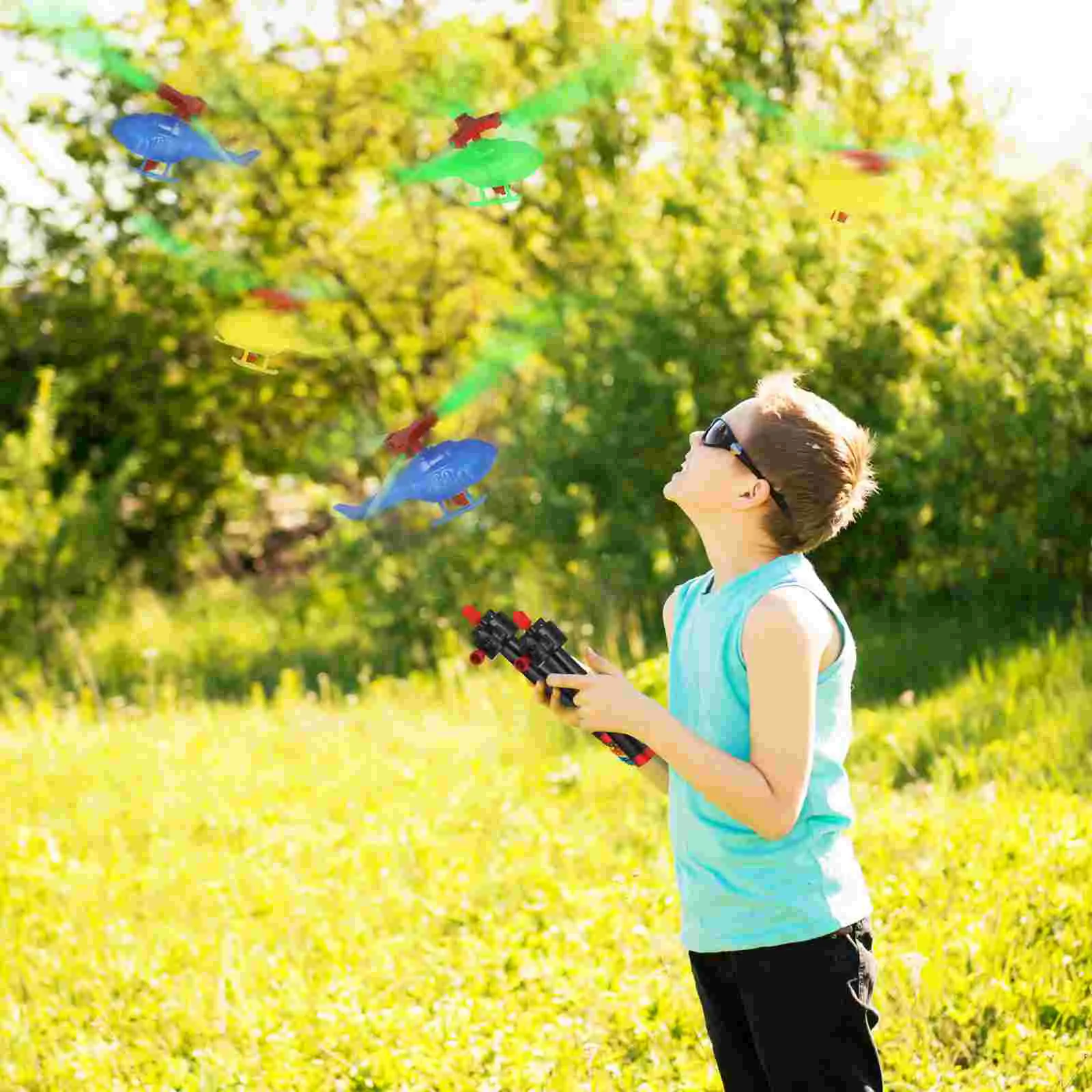 9pcs Pulling Flying Toys Airplane Toys Launcher Toys Handheld Helicopter Toys Outdoor Activity