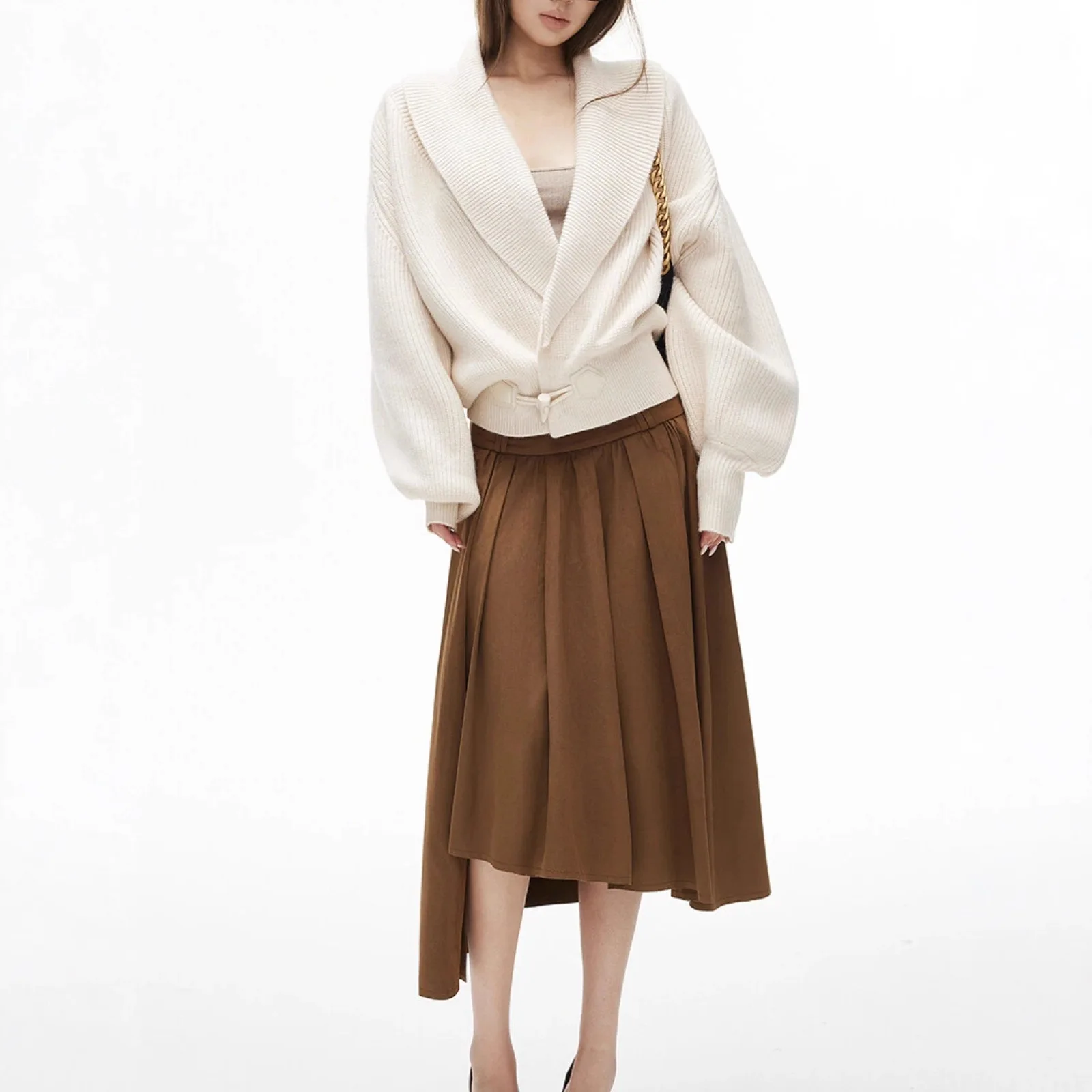 Vertical pit collar, flip collar, overlapping placket, horn buckle, lantern sleeves, loose white and black sweater view 3