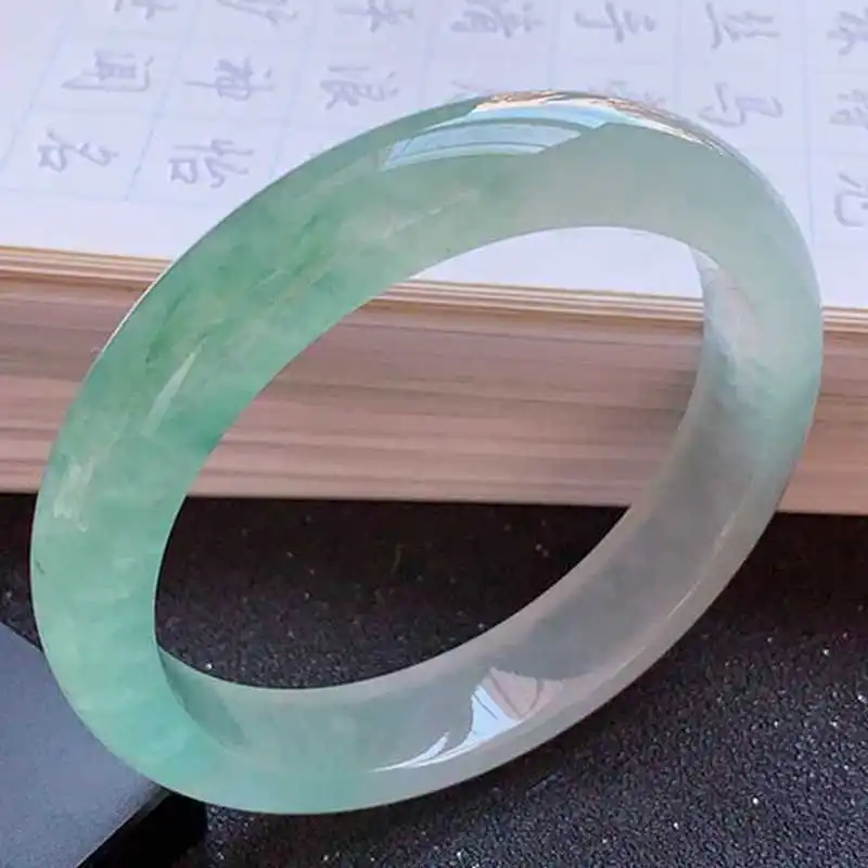 Ice-type jade bracelet with inclusions, featuring a light green, floral patterned design, suitable for women, and availabl