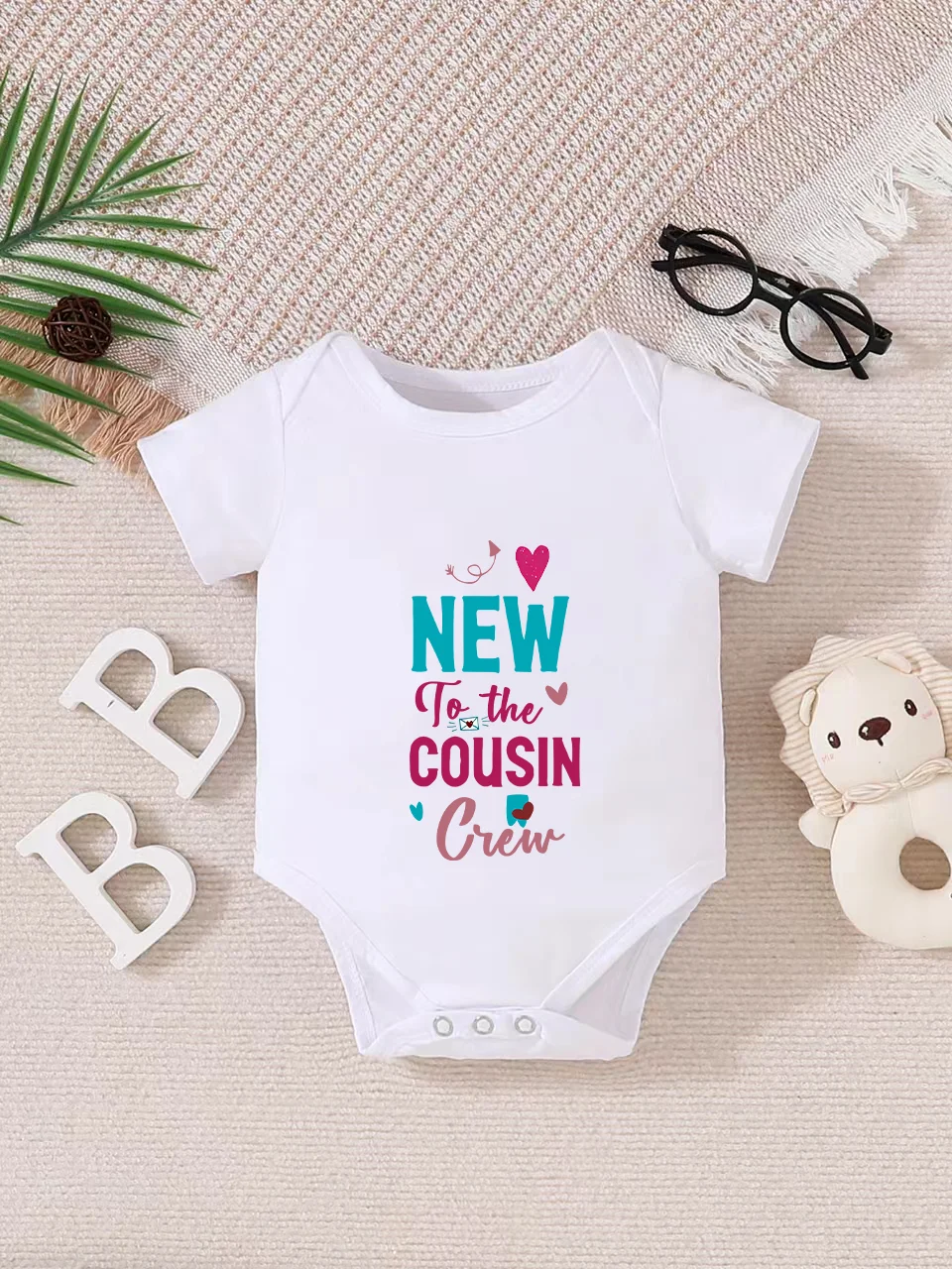 

Playful letter-printed baby short-sleeve triangle bodysuit. Button closure for easy dressing, machine washable