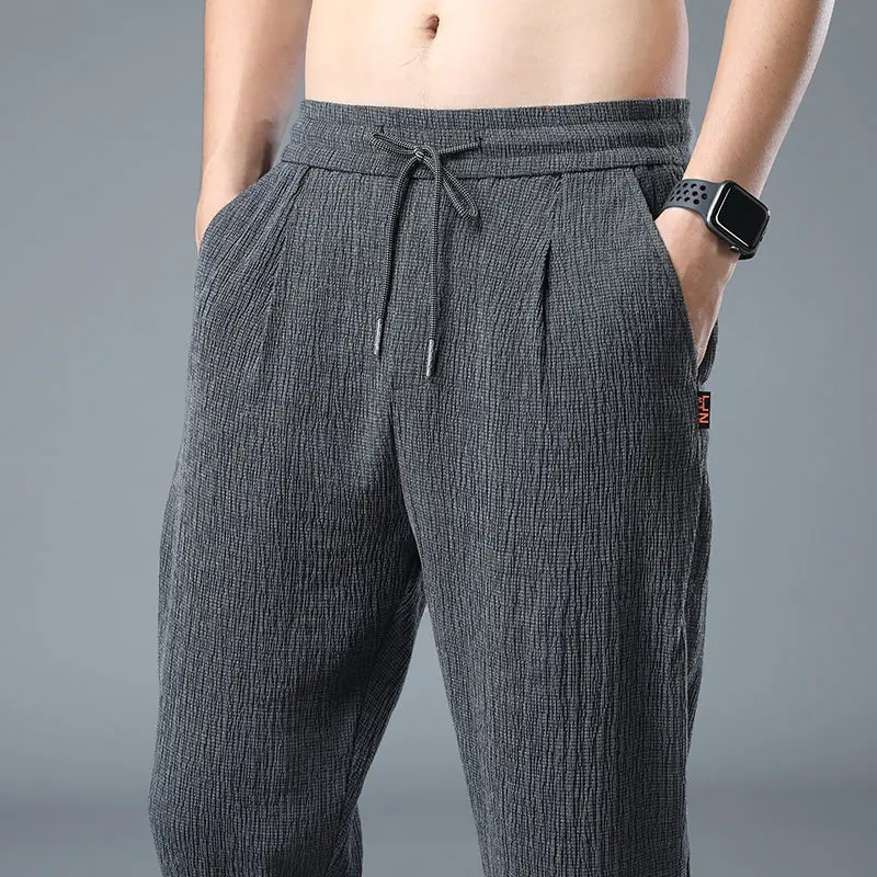 Pantaloni Casual elastici sottili estivi da uomo con cinturino in seta di ghiaccio pieghettato solido pantaloni dritti larghi con coulisse a vita alta 2023 nuovo