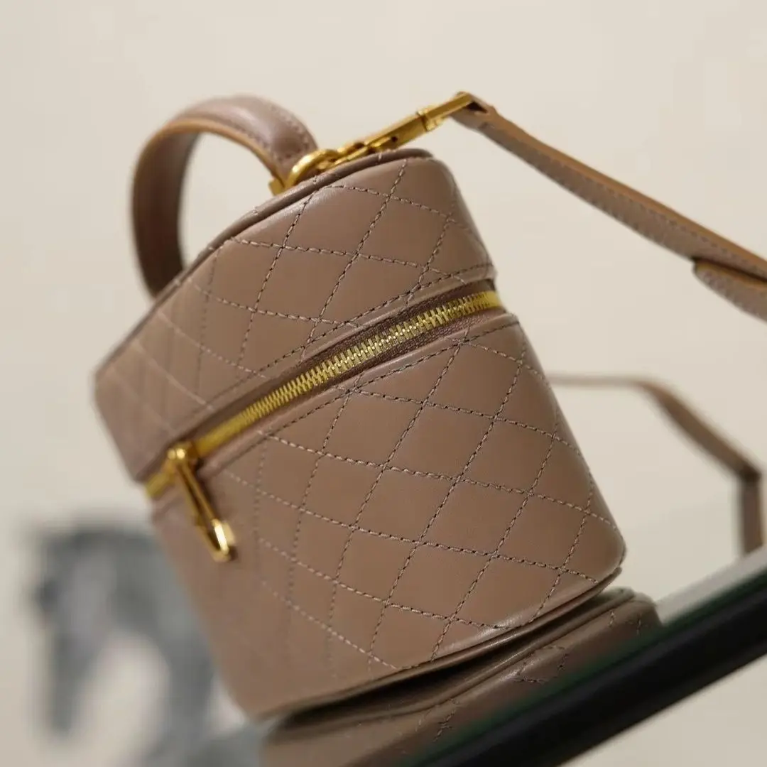 Nude diamond-patterned mini makeup bag handbag with gold double zipper hardware, top handle, and detachable thin crossbody strap.