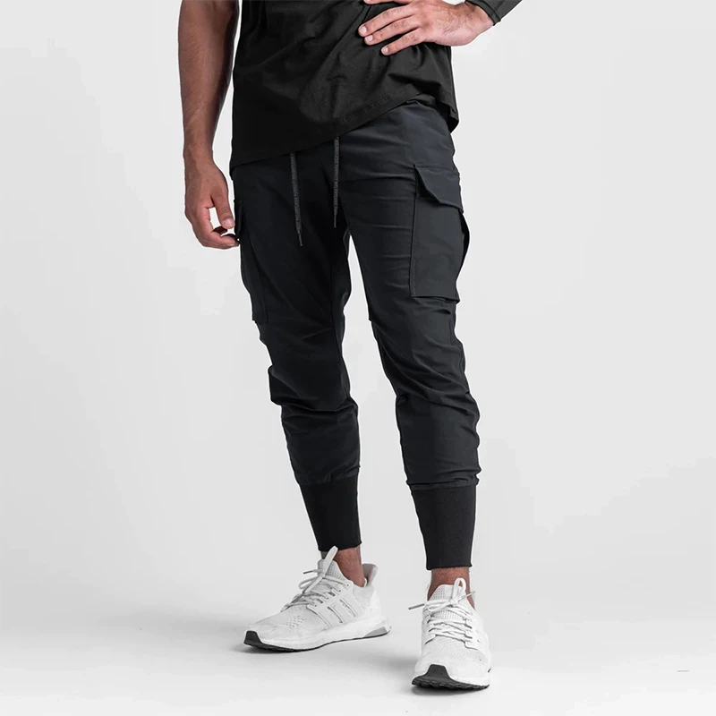 Pantalones deportivos elásticos de secado rápido para hombre, pantalones de entrenamiento deportivos finos y sueltos con bolsillos, ropa de trabajo, diseño 2025