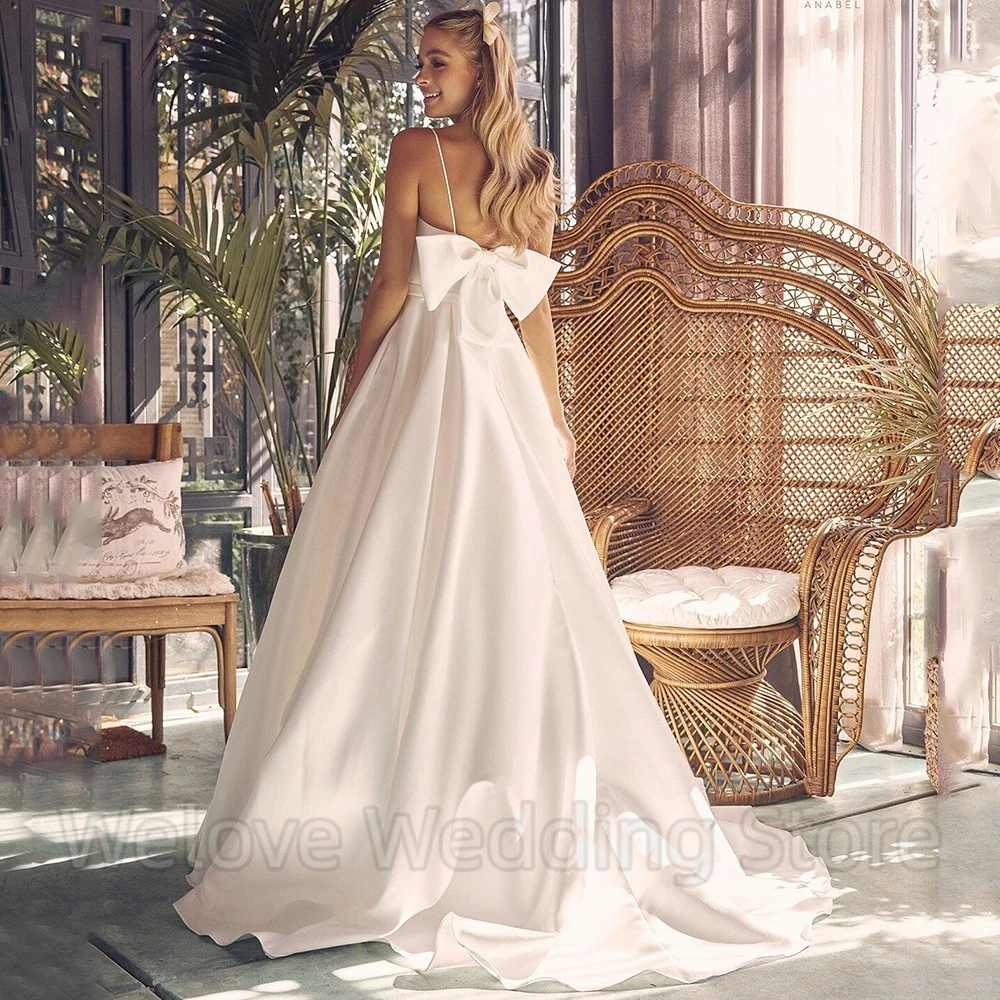 Spaghetti Straps Sleeveless Wedding Dress A-Line with Belt and Pocket Satin Square Collar Bow Sweep Train Bridal Open Back Gowns
