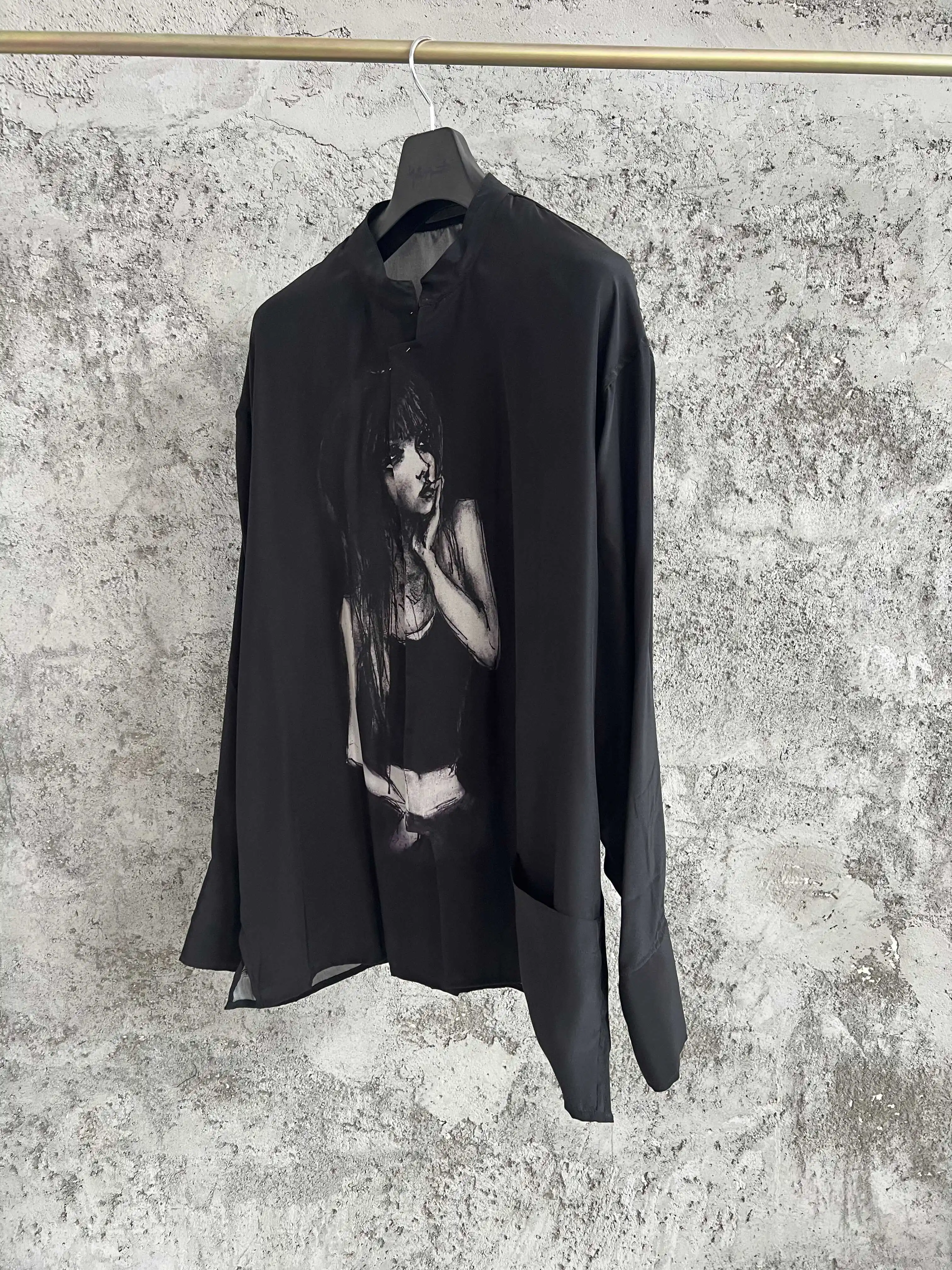 A loose, printed, casual black long-sleeved silk shirt with a thin profile