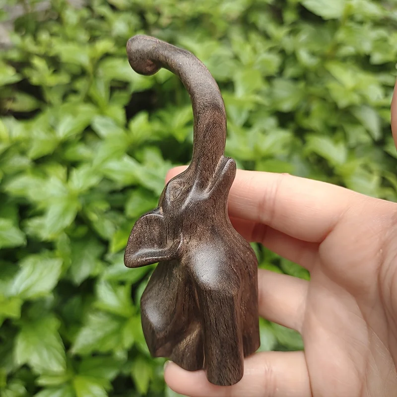 Solid wood elephant ornament, with raised trunk and ear contours, suitable for office use. Simple line design, a legacy of craftsmanship, offering peace and protection. A premium decorative piece for multiple settings