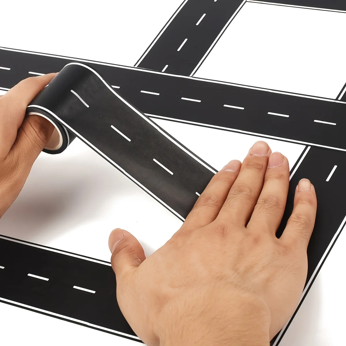 2/5 roll of easy-peel, no-slip race tape, in black and white design, perfect for event and party decoration