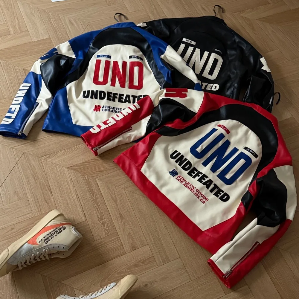 UNDEFEATED Unisex Racing Leather Moto Jacket Zip Up Stand Collar Color Block Biker Coat with Embroidered Patch Streetwear