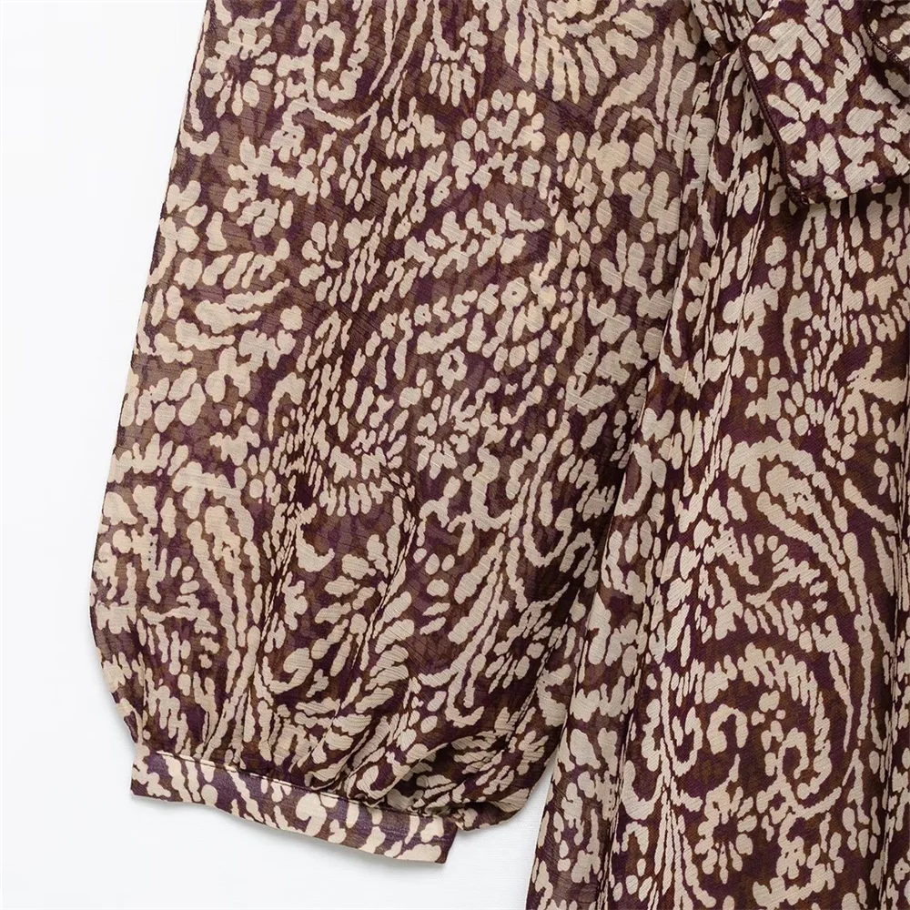 PB&ZA's new women's dress features a V-neck, long puff sleeves, knot details and paisley pattern for a vintage look