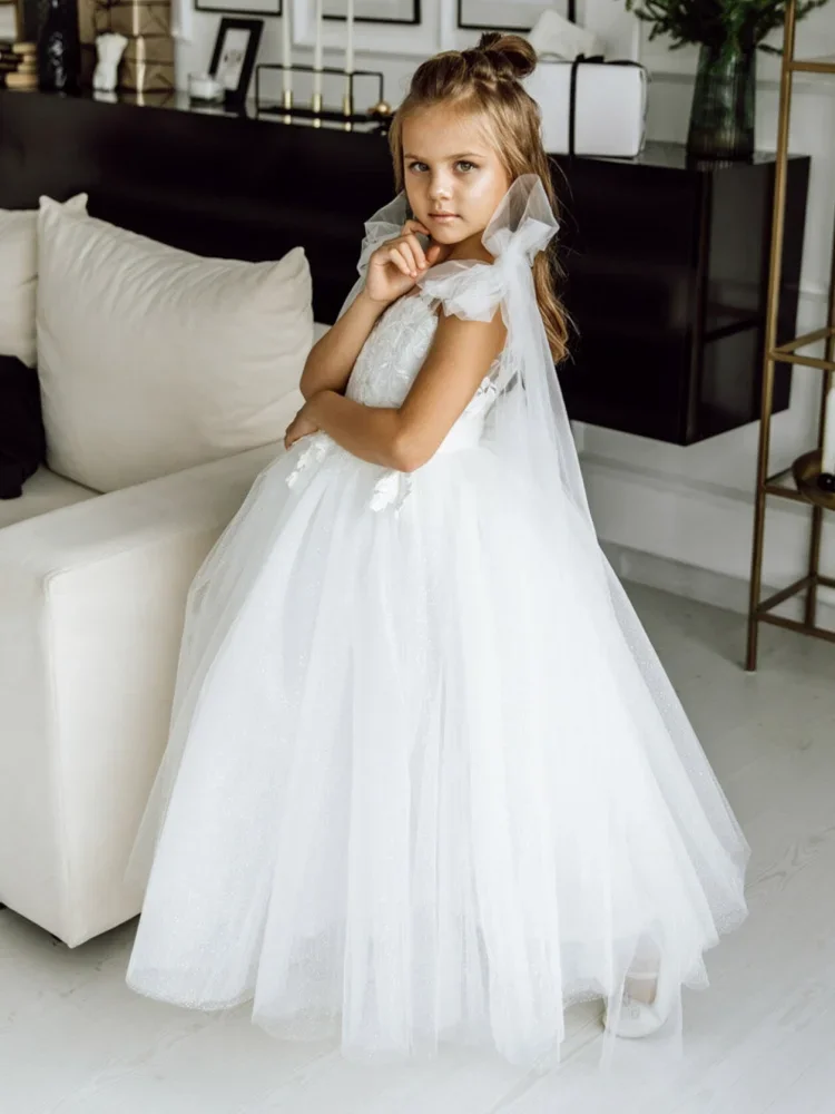 Con coda e spalla con fiocco senza maniche per matrimonio, compleanno, abiti da prima comunione, abiti da ragazza di fiori, applicazioni in tulle bianco