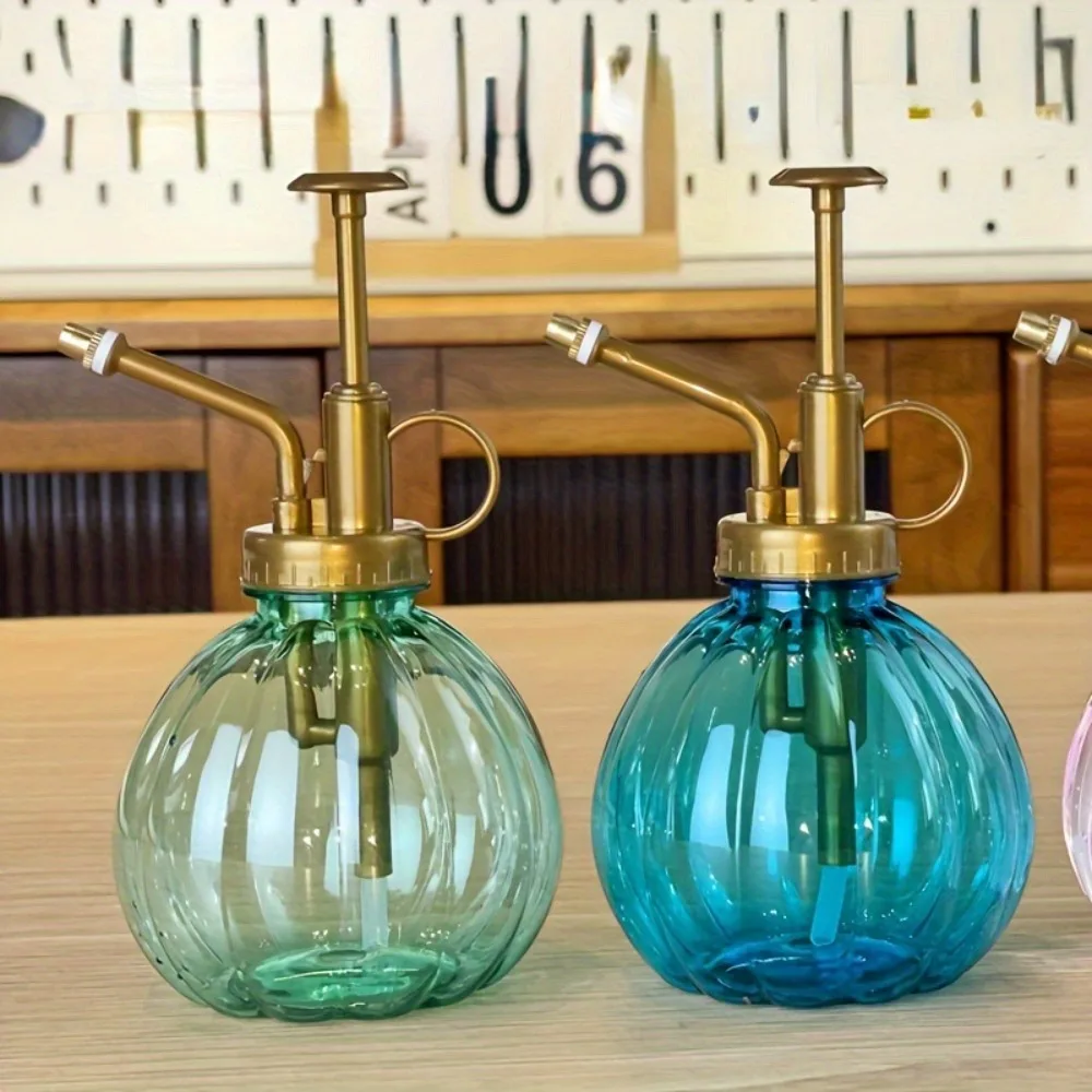 An antique plastic pumpkin shaped garden watering pot, a general holiday plant care spray, with an adjustable nozzle