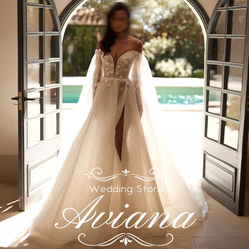 فستان زفاف Aviana مخصص قبالة الكتف وأكمام طويلة ورقبة على شكل V عميقة ومطرز بالخرز من الدانتيل مع فتحة عالية وقطار طويل