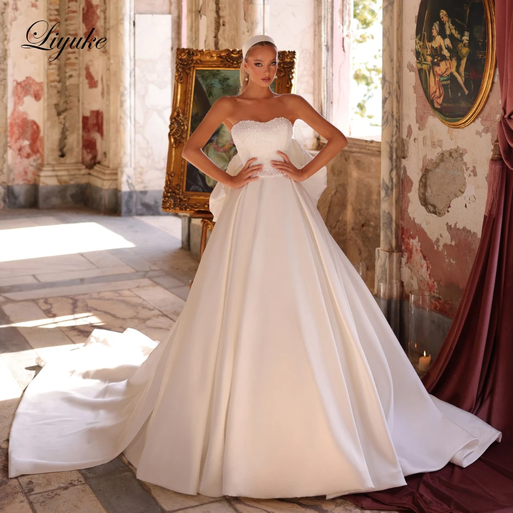 Liyuke Custom Made Elegant Satin Simple A-Line Wedding Dresses With Bow Removable Train Beading Pearls Sweetheart Bridal Dress
