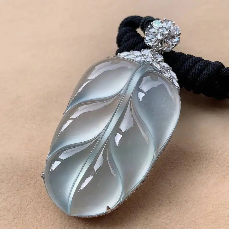 Natural ice pendant from Myanmar's old mines, inlaid with 1k gold, featuring a golden branch and jade leaf design
