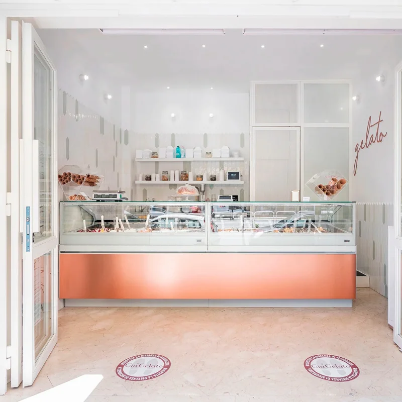 

custom.Creamy Aesthetic Gelateria with Terracotta Lacquer Cabinetry, Glass Display Freezer & Custom Solid Wood Storage