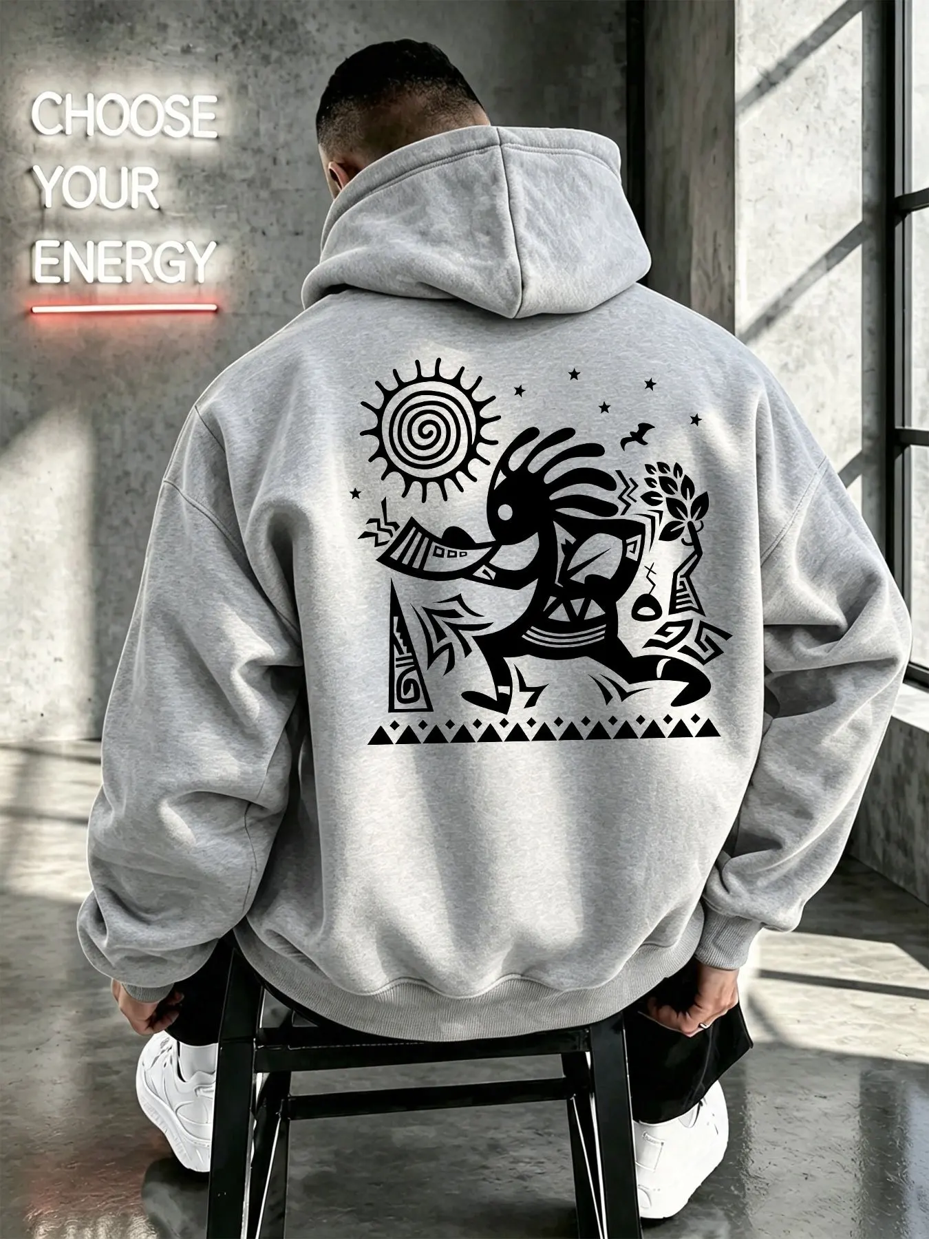 Men's hoodie featuring a Kokopelli sun totem and tribal folk-style line art print; Western-inspired primitive tribal aesthetic.