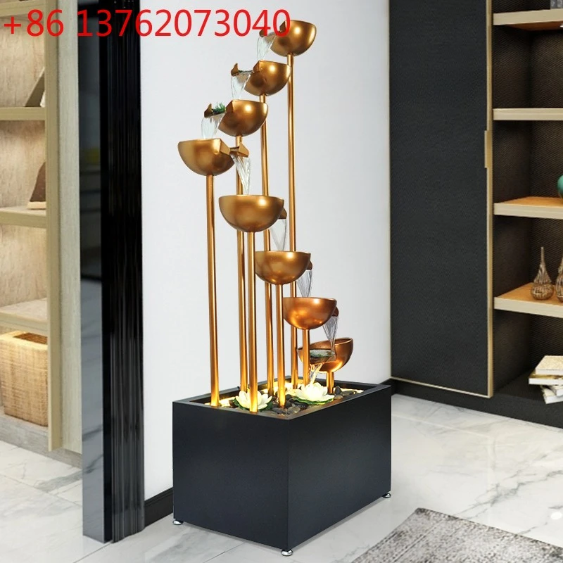 

TV cabinet next to the ornament large floor running water fountain circulating water light luxury simple interior decoration