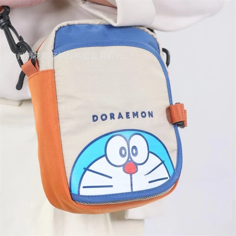 

Новая милая компактная сумка для телефона с изображением Дораэмонов, стильная сумка через плечо с цветовыми блоками, повседневная сумка для необходимых вещей.