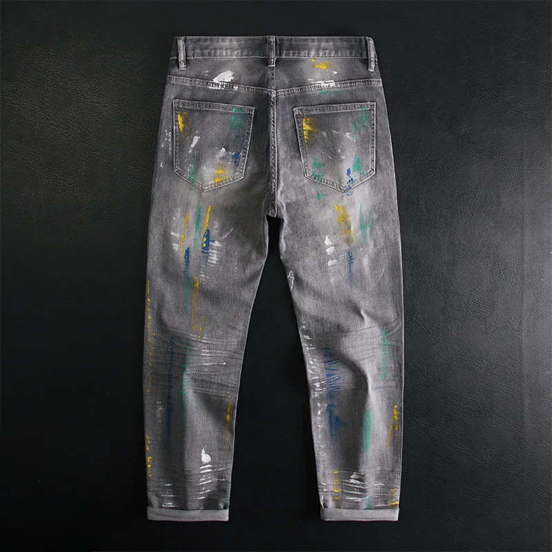 Broken hole patch graffiti splicing jeans for men, slim fit with small feet, elastic retro splashed ink high-end trendy pants