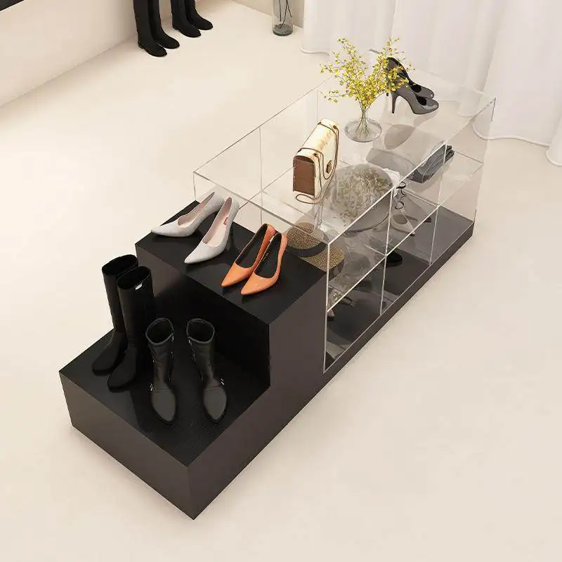 The clothes store is located in middle of  shopping mall with an acrylic storage display stand for women's clothing store
