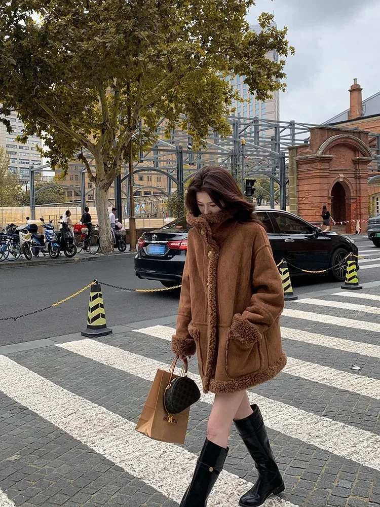 A medium-length winter lambskin coat for women, featuring fur on both sides