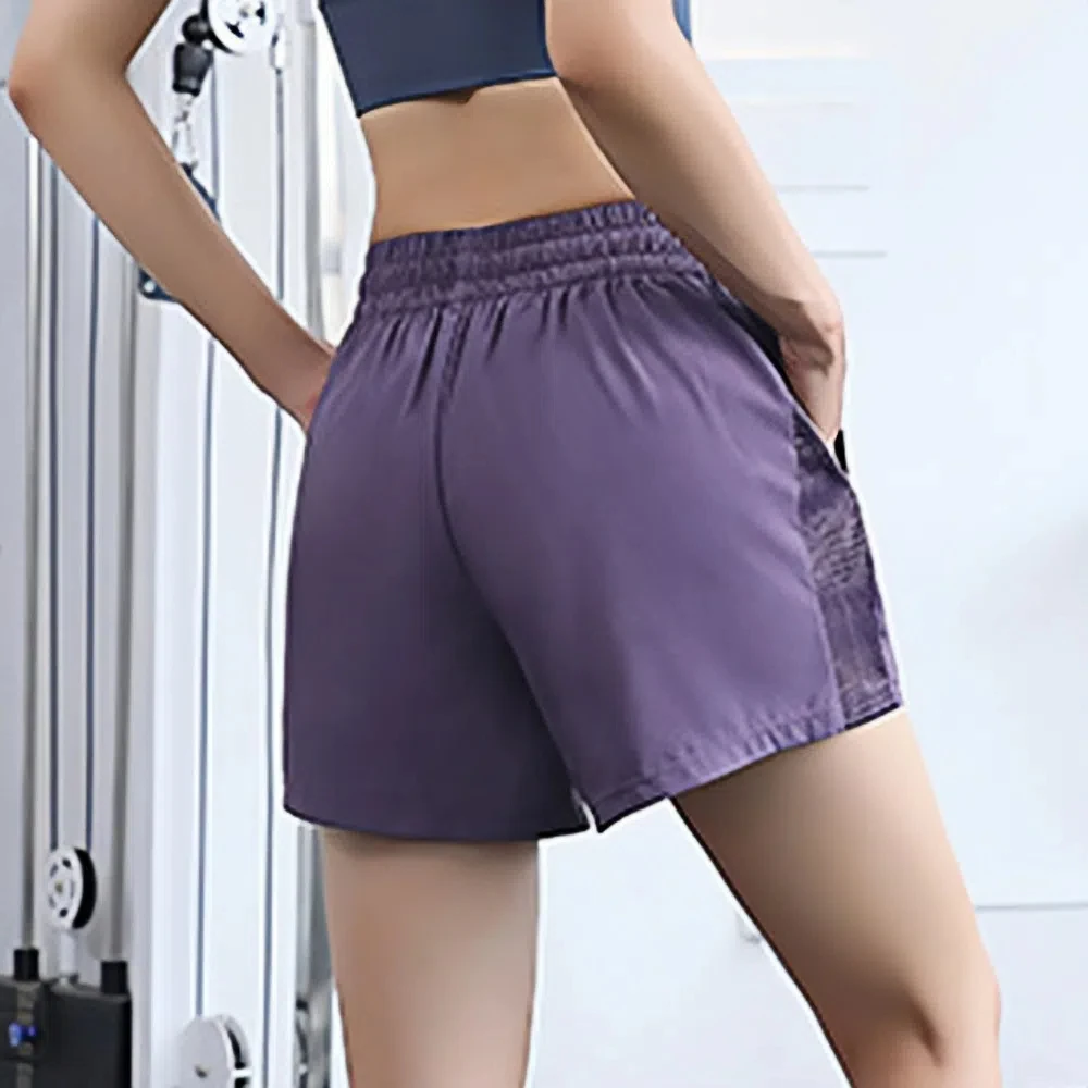Pantaloncini sportivi da corsa Pantaloncini da yoga con design a rete Tasche laterali Orlo Pantaloncini sportivi elastici Pantaloncini fitness larghi e traspiranti Yoga
