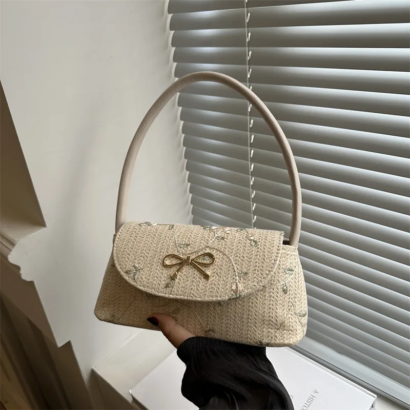 Korean version of fashionable versatile straw woven bag women's high-end bow thorn shoulder embroidered armpit bag