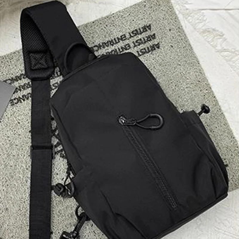 

Женская и мужская функциональная нагрудная сумка нейтрального стиля, подходящая для деловых прогулок. Чистый черный нейлоновый материал.