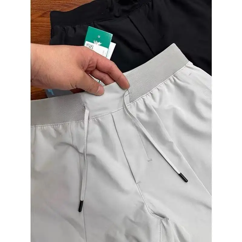 

Новые летние мужские брюки в американском стиле, тонкие дизайнерские свободные спортивные повседневные брюки большого размера с пятью четвертью, молодежная активная одежда из полиэстера...