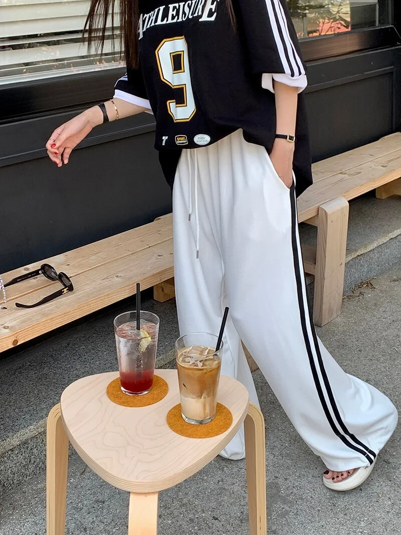 กางเกงขายาวลายทางลำลองสำหรับผู้หญิง เอวยางยืดแบบผูกเชือก ทรงหลวม ใส่สบาย ช่วยพรางหุ่น แฟชั่นทันสมัย