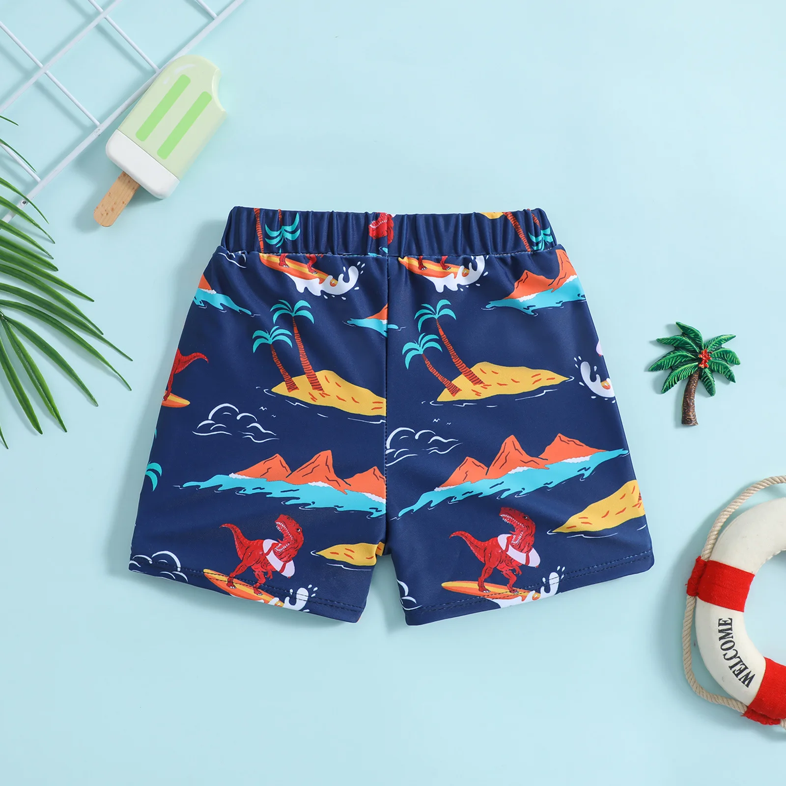 Boys drawstring swim shorts with surfing dinosaur island print suitable for seaside and pool play