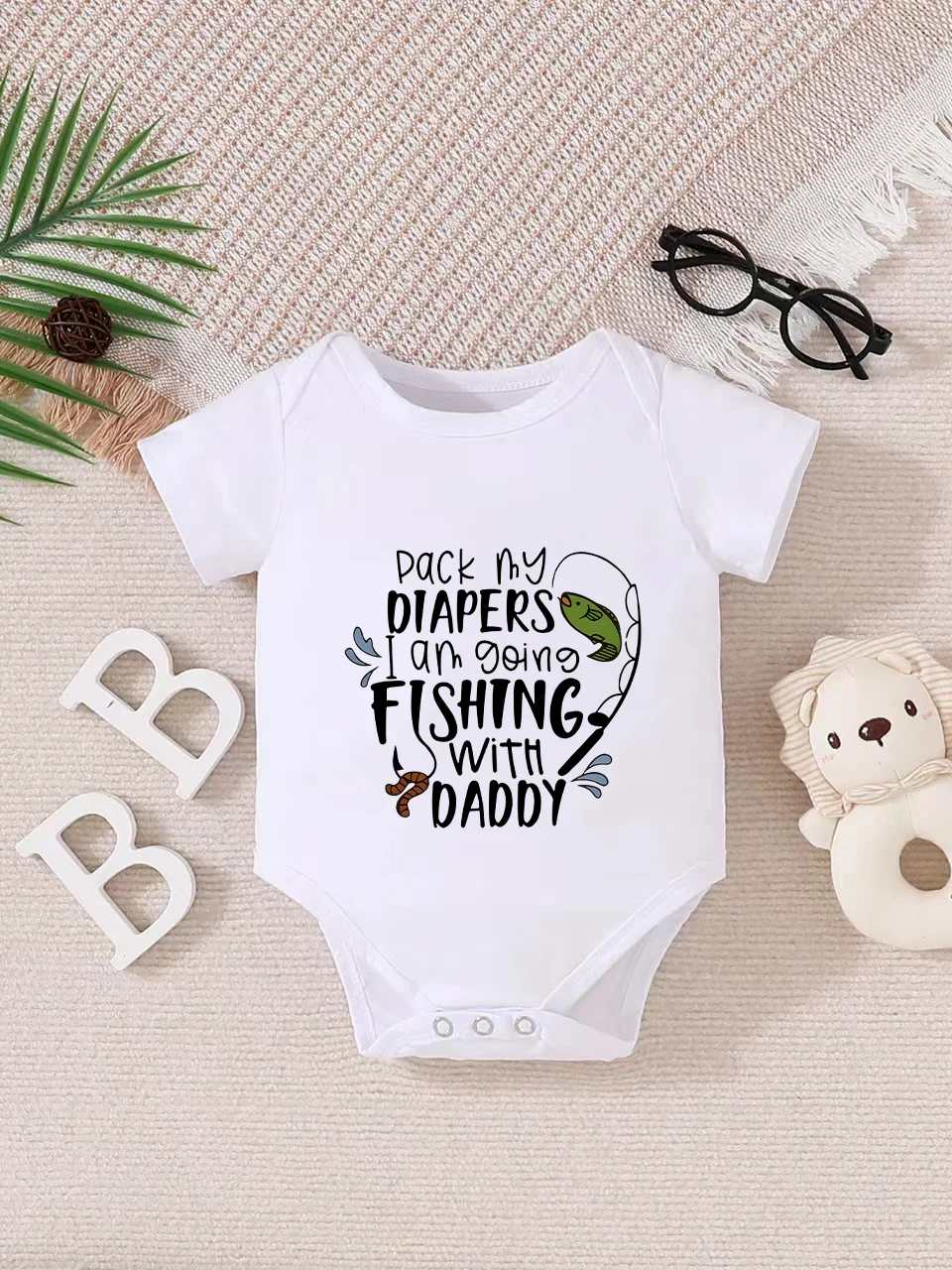 Playful letter-printed baby short-sleeve triangle bodysuit. Button closure for easy dressing, machine washable