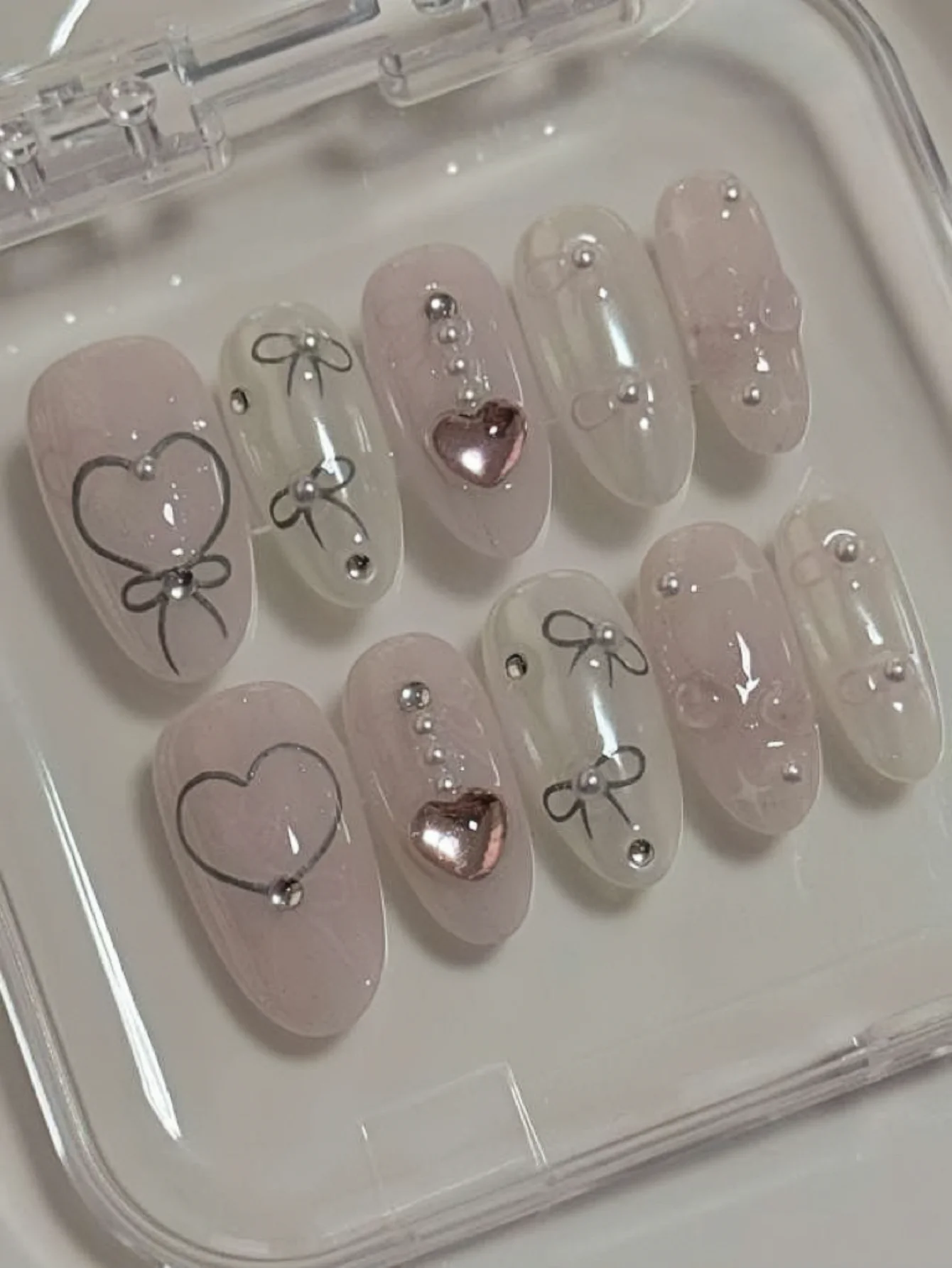 10-Piece Set of Korean-Style Sweet Wearable Nails, Short Oval Shape, Sheer Pink Nude Color, Hand-Painted Heart Bow, Reusable Fake Nails with Metal Heart Beads