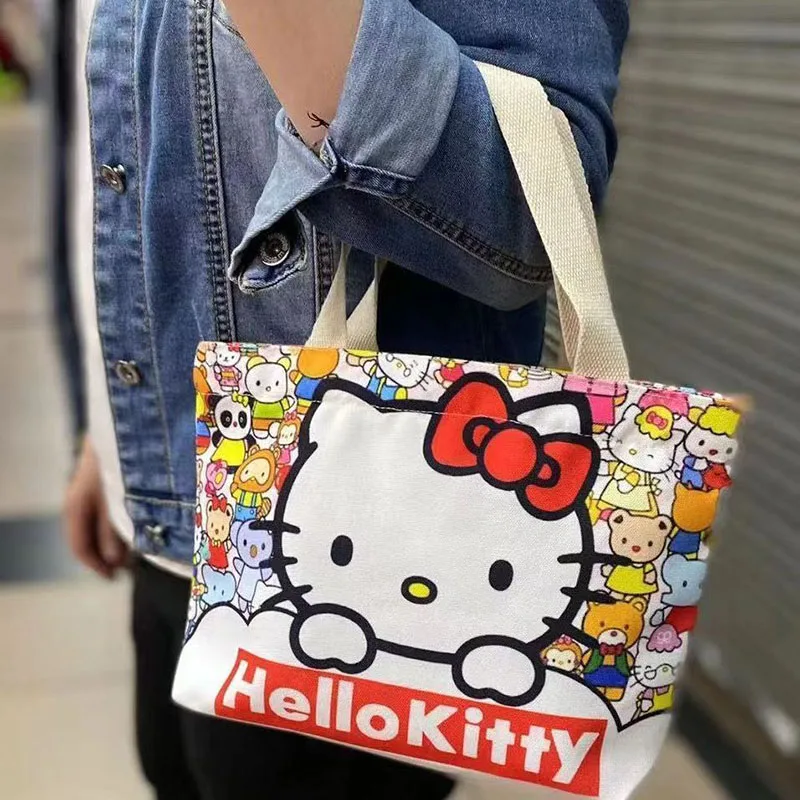 Sanrio Hello kittys กระเป๋าถือการ์ตูนน่ารักอะนิเมะ Kawaii สร้างสรรค์พิมพ์อเนกประสงค์เดินทางกระเป๋า tas Jinjing kanvas แบบพกพาของเล่นสำหรับเด็กผู้หญิงของขวัญ