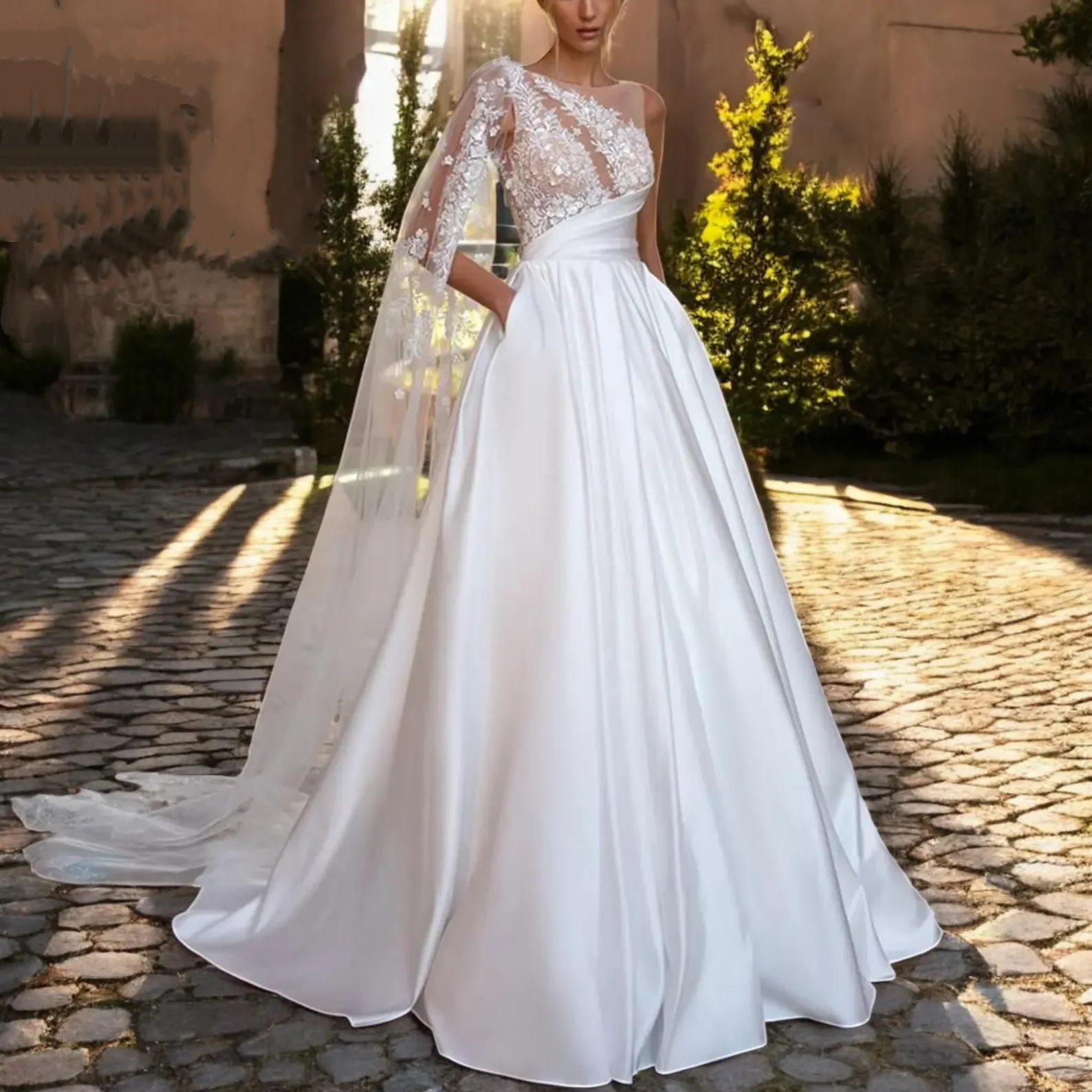 

Customized 2025 Wedding Dress With One Shoulder Lace Decal Dress And Transparent Cape, Backless Design Satin Large Skirt
