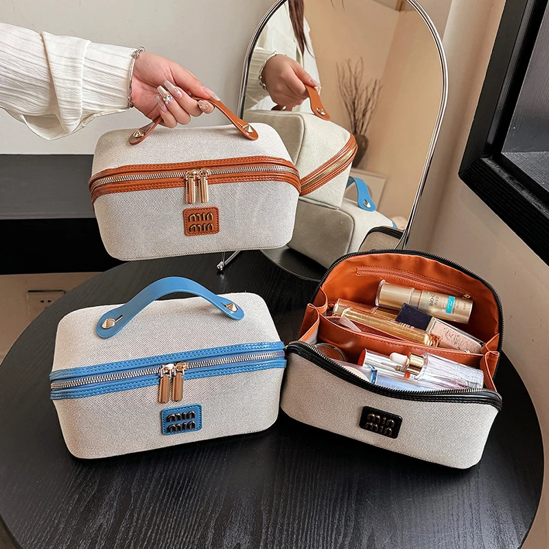 Cosmetic bag female 2025 high-end light luxury designer new canvas portable large-capacity travel partition cosmetic storage bag