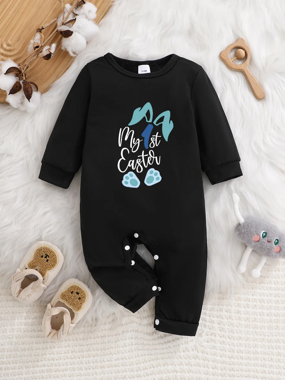 A baby long-sleeved onesie with interesting letter prints. It features a buttoned design for easy putting on and taking off, and