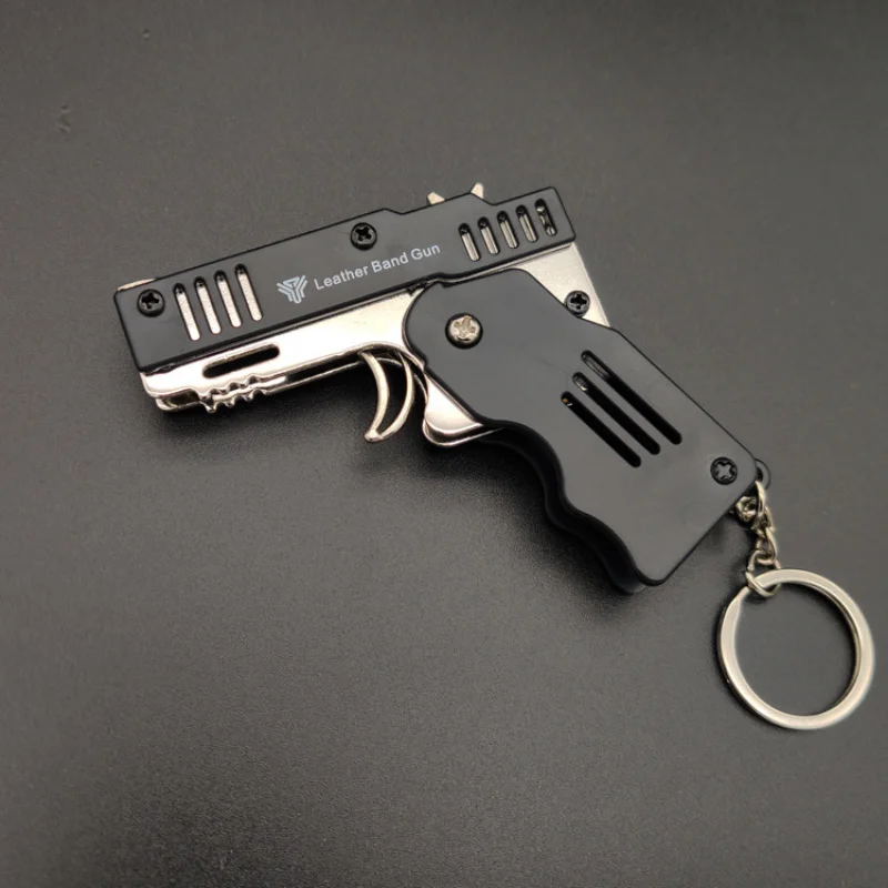 Mini pistola de goma completamente de Metal, se puede plegar como un llavero, juguete de regalo para niños, seis ráfagas de pistola de juguete de goma