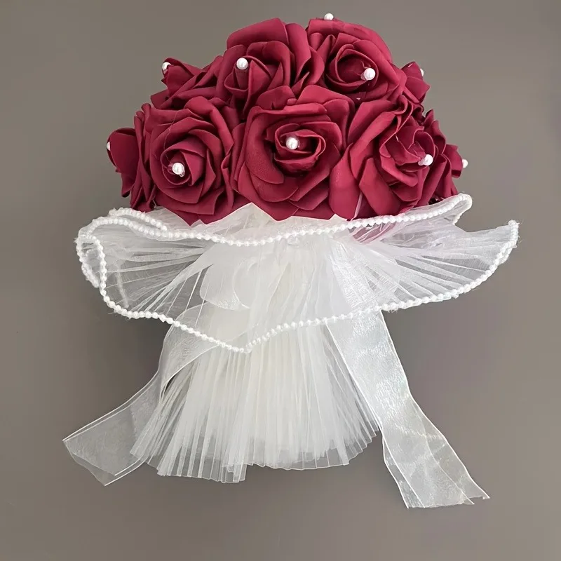 A wedding dress adorned with beautiful and captivating pearls, surrounded by rose-shaped artificial bouquets held in the hands