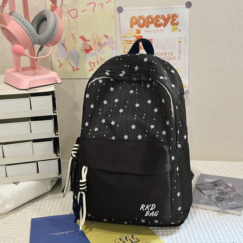 Fresh and stylish Korean-style star backpack for female middle school students, attractive printed lightweight waterproof backpa