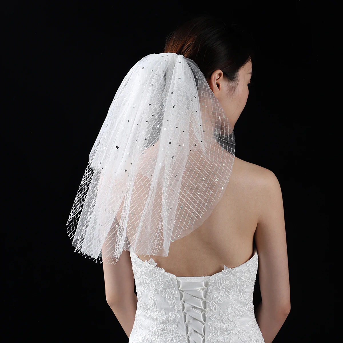 A white elegant bridal veil with a shoulder length veil adorned with sequins, suitable for women's weddings