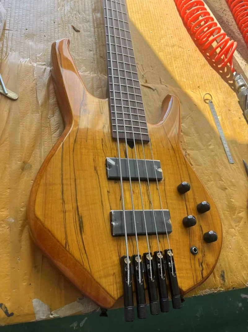 

Custom 5-string headless electric bass, black neck, rosewood fingerboard, map-patterned maple top, black hardware, free delivery