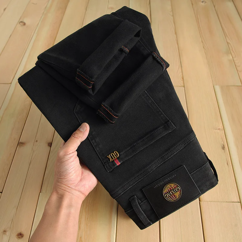 Jeans hitam murni klasik pria, celana Jin hitam murni klasik lurus ramping elastis dicuci Vintage sederhana kelas atas celana mewah terjangkau