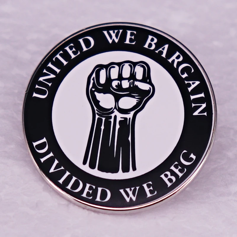 United We Bargain, Divided We Beg: The Real Story Behind the Fist Enamel Pin That’s Turning Heads