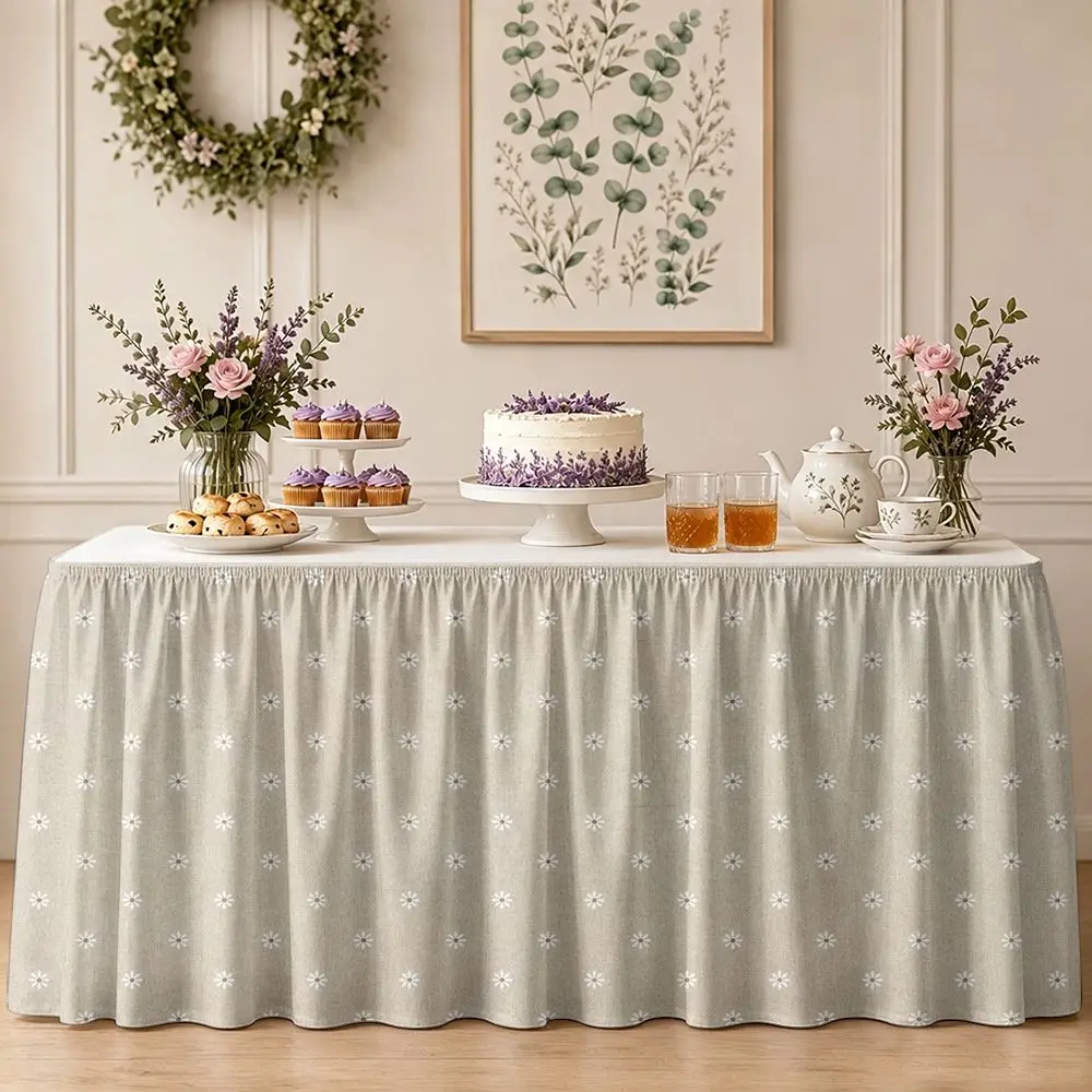 One table skirt. Made of beige fabric with a white daisy pattern. With ruffled edges.