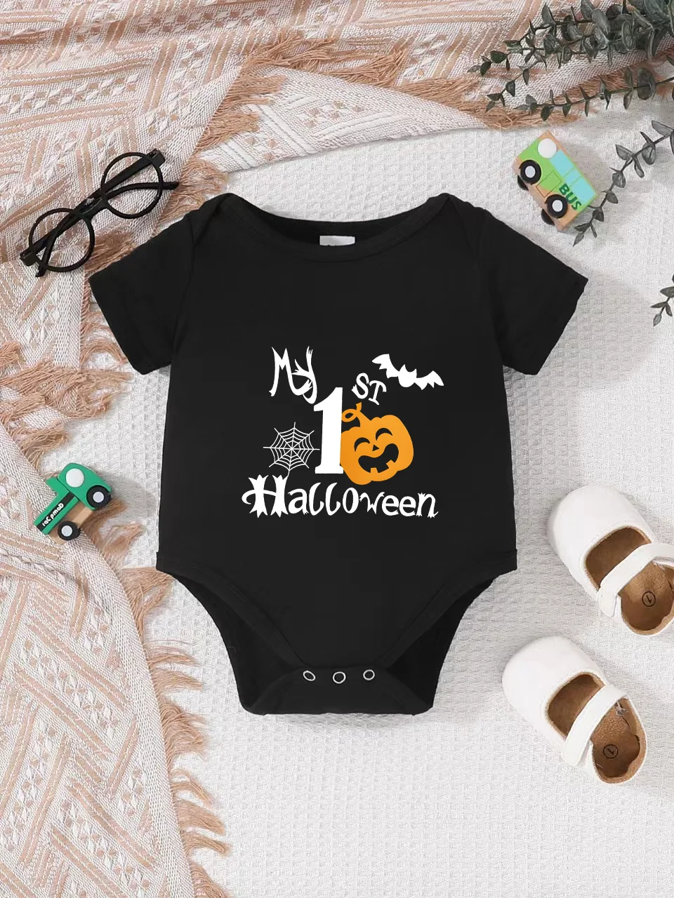 Playful letter-printed baby short-sleeve triangle bodysuit. Button closure for easy dressing