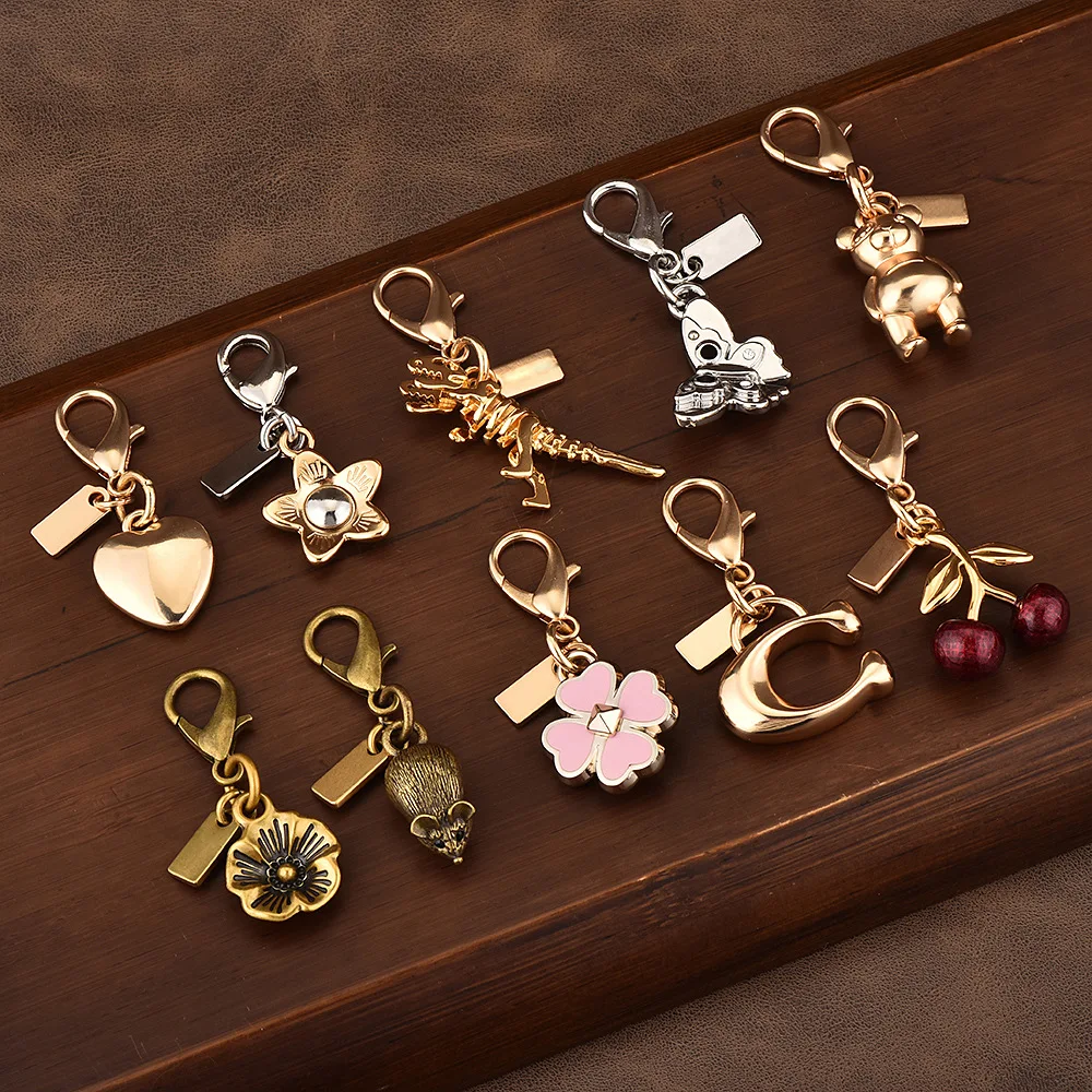 

Car key pendants, high-end bag accessories, golden bear, cherry, four-leaf clover, butterfly schoolbag ornaments, bag pendants