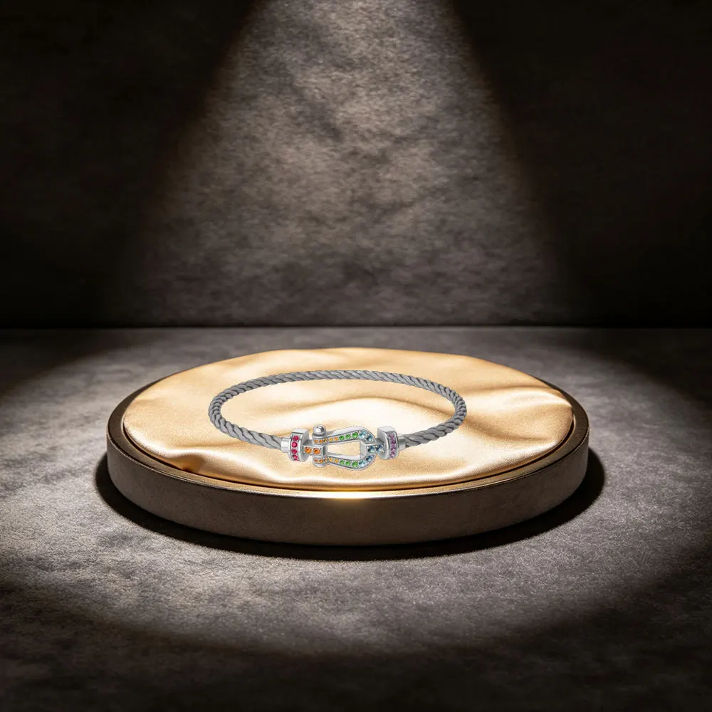 

An elegant and textured steel bracelet, equipped with various diamond-colored horseshoe-shaped clasps